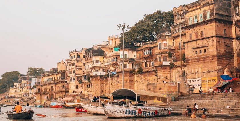 Varanasi ghat with pilgrims and boats, showcasing what is the best time to visit Varanasi.