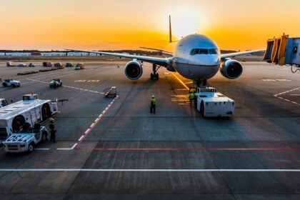 An airplane taking off at sunset with scenic skies at one of the airports in Bali.
