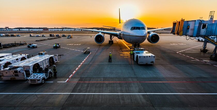 An airplane taking off at sunset with scenic skies at one of the airports in Bali.