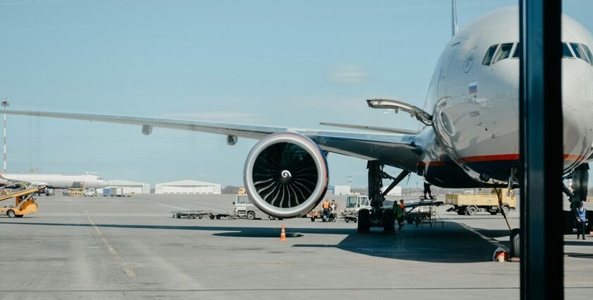 Aeroplanes parked at airport gates with staff and ground vehicles nearby, one of the Airports in North East.