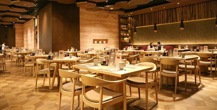 Interior of a restaurant with tables, chairs, and dim lighting, one of the best restaurants in Guwahati for dinner.