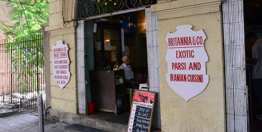 Front of Café du Commerce in Belley with black awning, wooden barrels, and seating, one of the best cafes in Kalimpong.