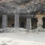 Four stone pillars and rugged rock formations at Kavala Caves, one of the popular caves in Karnataka.