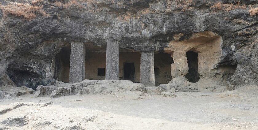 Four stone pillars and rugged rock formations at Kavala Caves, one of the popular caves in Karnataka.