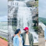 A breathtaking landscape of a couple enjoying their trip to Kerala amidst amazing views.