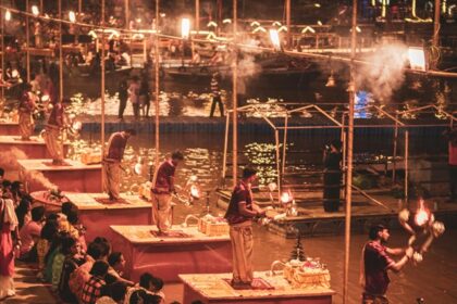 Ganga Aarti at Varanasi ghat during Dev Deepawali in Varanasi with glowing diyas and crowd.