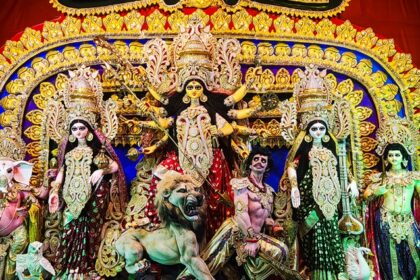 Inside view of a pandal displaying ornate idols of Goddess Durga during Durga Puja in Kolkata.
