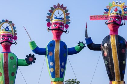 Tall Ravan effigy standing decorated during the day for the Dussehra celebration in India.