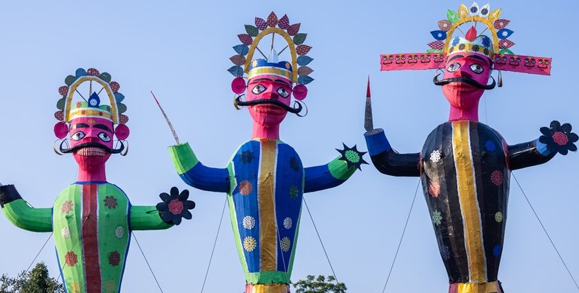Tall Ravan effigy standing decorated during the day for the Dussehra celebration in India.