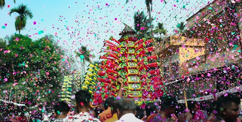 A group celebrating with confetti in a vibrant street event during festivals in Tamil Nadu.