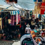 Assorted colorful clothes are displayed on a street at lively flea markets in Dubai.