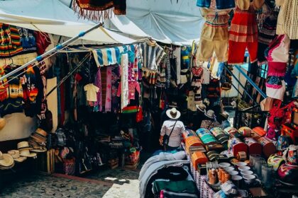 Assorted colorful clothes are displayed on a street at lively flea markets in Dubai.
