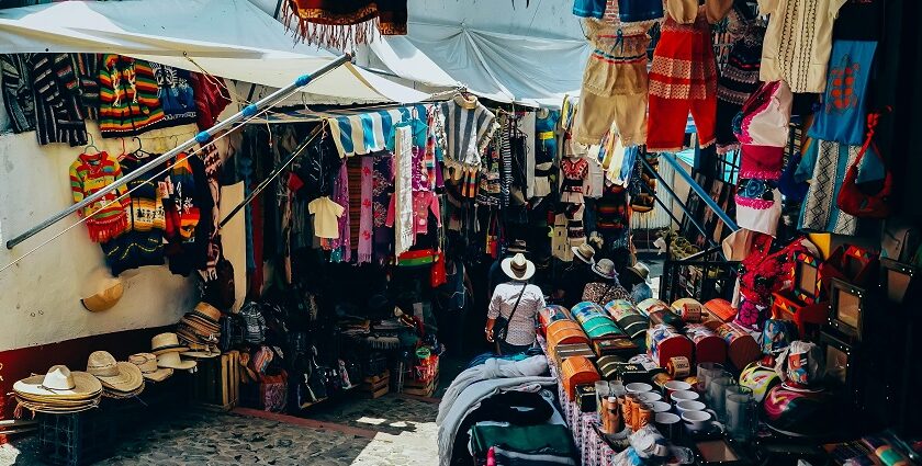 Assorted colorful clothes are displayed on a street at lively flea markets in Dubai.