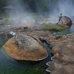 Scenic view of Chae Son Hot Springs in Thailand surrounded by lush greenery.