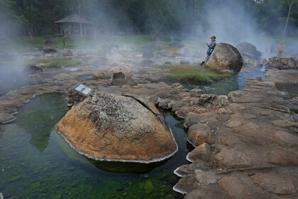 Scenic view of Chae Son Hot Springs in Thailand surrounded by lush greenery.