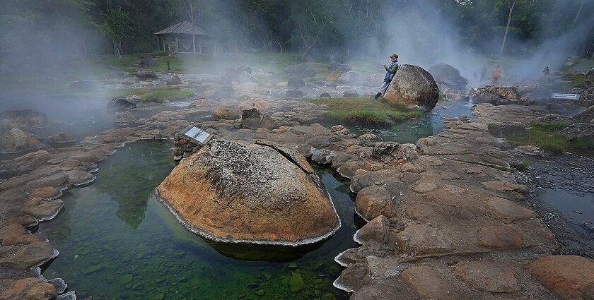 Scenic view of Chae Son Hot Springs in Thailand surrounded by lush greenery.