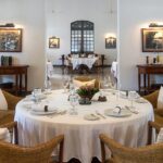 A spacious, elegant dining room with round tables and wicker chairs, and a smaller room in the back, one of the best Indian restaurants in Singapore.