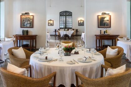 A spacious, elegant dining room with round tables and wicker chairs, and a smaller room in the back, one of the best Indian restaurants in Singapore.