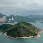 Several boats anchored near Middle Island surrounded by calm waters in islands in Hong Kong.
