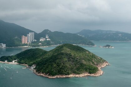 Several boats anchored near Middle Island surrounded by calm waters in islands in Hong Kong.