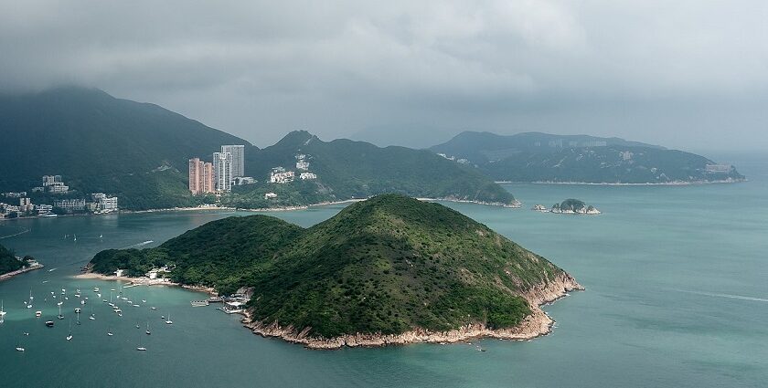 Several boats anchored near Middle Island surrounded by calm waters in islands in Hong Kong.