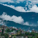 Aerial view of Darjeeling city near mountains, showcasing scenic landscapes and offbeat places in Darjeeling.