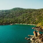 Butterfly Beach, with calm water surrounded by green hills, one of the best offbeat places in Goa.