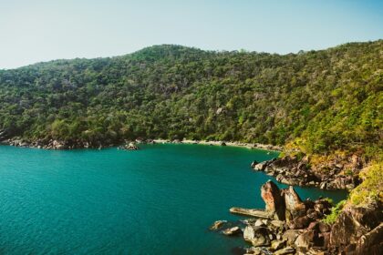 Butterfly Beach, with calm water surrounded by green hills, one of the best offbeat places in Goa.