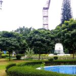 Pond view with trees and a walking path in Mahatma Gandhi Park, one of the best parks in Karnataka.