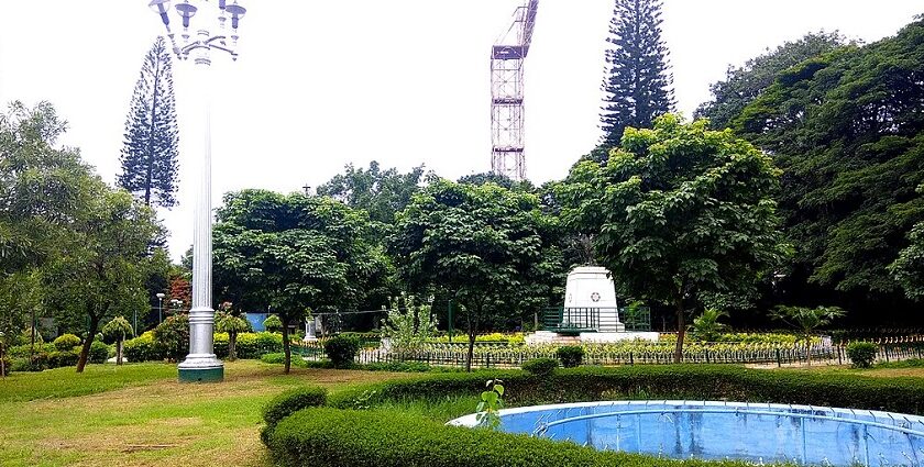 Pond view with trees and a walking path in Mahatma Gandhi Park, one of the best parks in Karnataka.