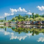 Dal Lake shikara ride with mountains in view, one of the top picnic places in Kashmir.