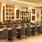 Luxurious interior of Kok Sen Restaurant with elegant chairs, golden décor, and lighting, one of the best restaurants in Chinatown.