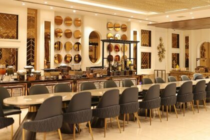 Luxurious interior of Kok Sen Restaurant with elegant chairs, golden décor, and lighting, one of the best restaurants in Chinatown.