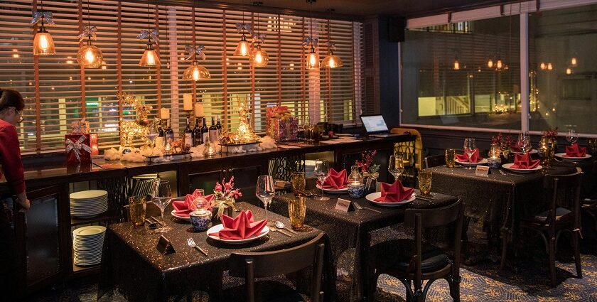 Elegant dining space with glowing lights, festive décor, and tables set with red napkins, one of the best restaurants in Clarke Quay.