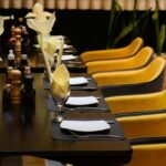Khushboo restaurant interior with yellow chairs, one of the best restaurants in Fancy Bazar Guwahati.