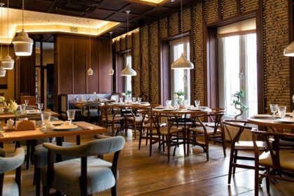 Interior of Taste Of Tibet with tables, chairs, and hanging lights, one of the top restaurants in Gangtok.
