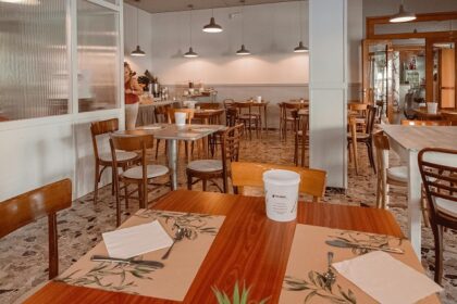 A restaurant with wooden chairs, pendant lights, and a warm interior, one of the best restaurants in Namchi.