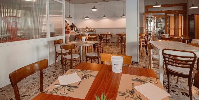 A restaurant with wooden chairs, pendant lights, and a warm interior, one of the best restaurants in Namchi.