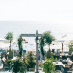 White patio table set at MAVI Rooftop Lounge near the ocean, perfect for dining at restaurants in Port Blair.