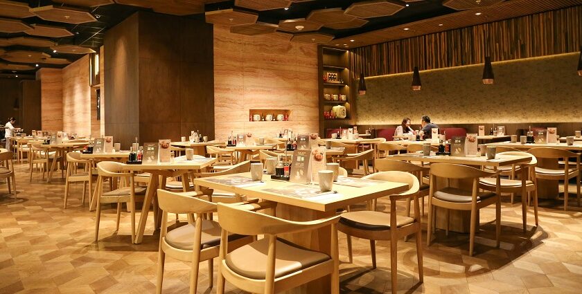 A large room with tables and chairs at The Deck, one of the restaurants in Sevoke Road Siliguri.