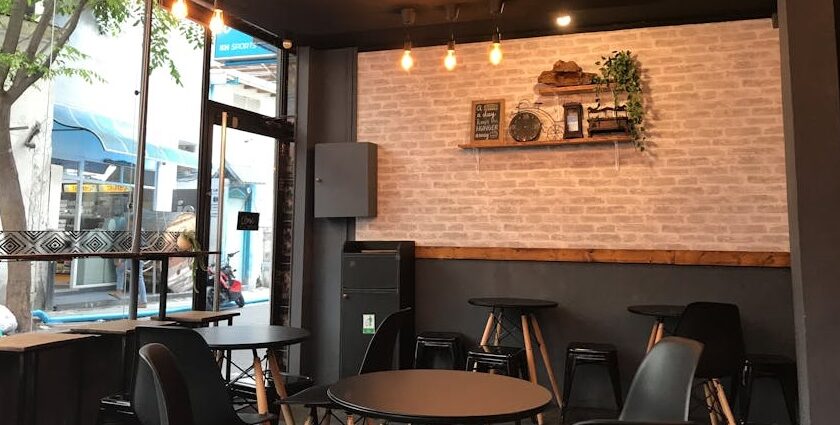 Restaurant interior with tables, chairs, and hanging lights at one of the restaurants in Woodlands.
