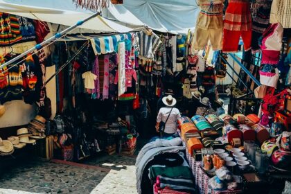 Assorted colourful clothes displayed at a bustling Jade market, one of the best street markets in Hong Kong.