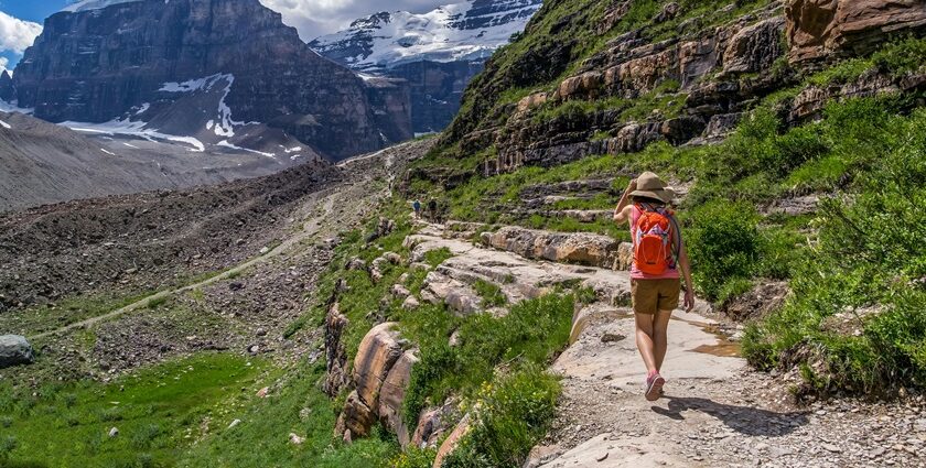 Person walking on a scenic mountain trail during trekking in Thailand.