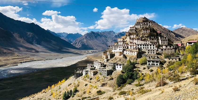 Fields and houses in Spiti Valley, Himachal Pradesh, under tall mountain ranges.