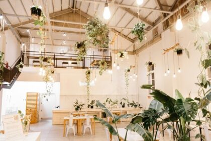Tom & Jerry's Cafe interior with wooden tables, planters, and elegant decor, one of the beautiful cafes in Darjeeling.