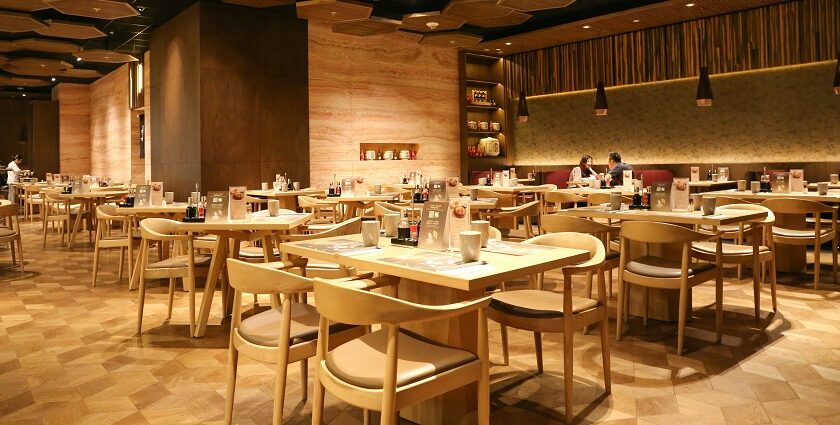 Cosy interior of Nagameez with table, chairs, and dim lights, one of the best restaurants in Beltola Guwahati.