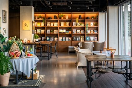 Salt & Pepper Bistro interior with tables, chairs, and wall-mounted bookshelf, one of the best couple restaurants in Dibrugarh.