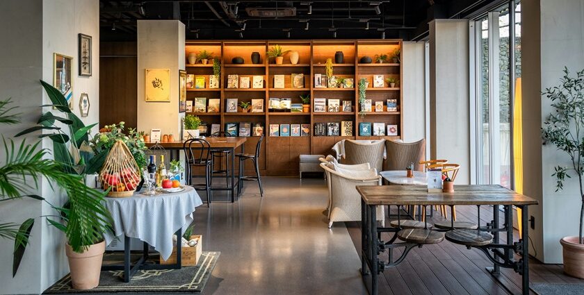 Salt & Pepper Bistro interior with tables, chairs, and wall-mounted bookshelf, one of the best couple restaurants in Dibrugarh.