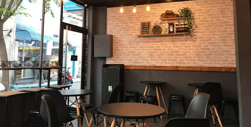 Bombay Brasserie interior with black tables, chairs, and lights, one of the best restaurants Paltan Bazar Guwahati.