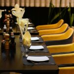 Skyscape Guwahati interior with long table and chairs, one of the best rooftop restaurants in Guwahati.